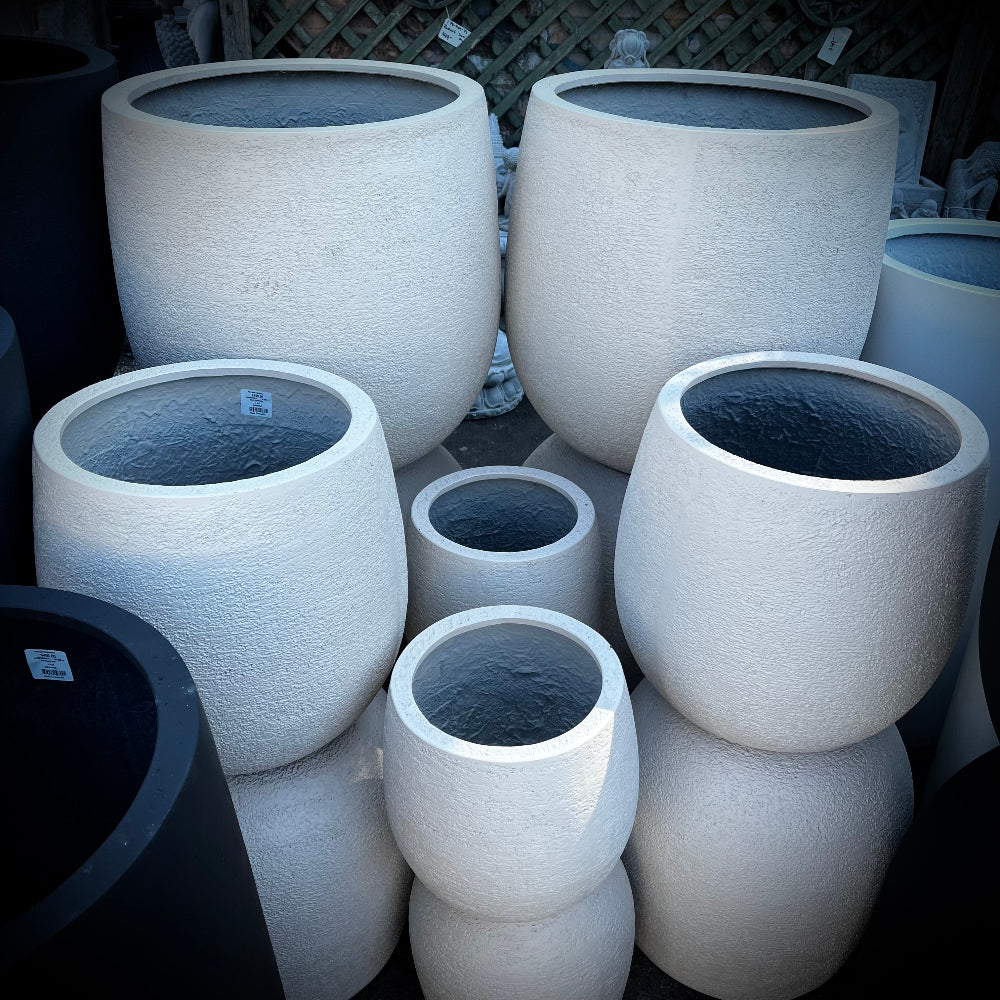 Set of stone-textured planters of various sizes.